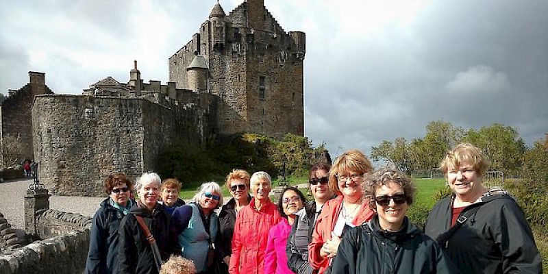 A Sights and Soul tour of Scotland in front of the 13C Eileen Donan castle (Photo courtesy of Sights and Soul)