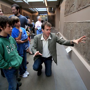 A University of London archaeologist, hired through Context Travel, guides a family through the British Museum in London (Photo courtesy of Context Travel)