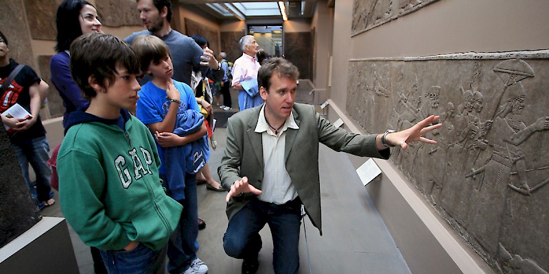 A University of London archaeologist, hired through Context Travel, guides a family through the British Museum in London (Photo courtesy of Context Travel)